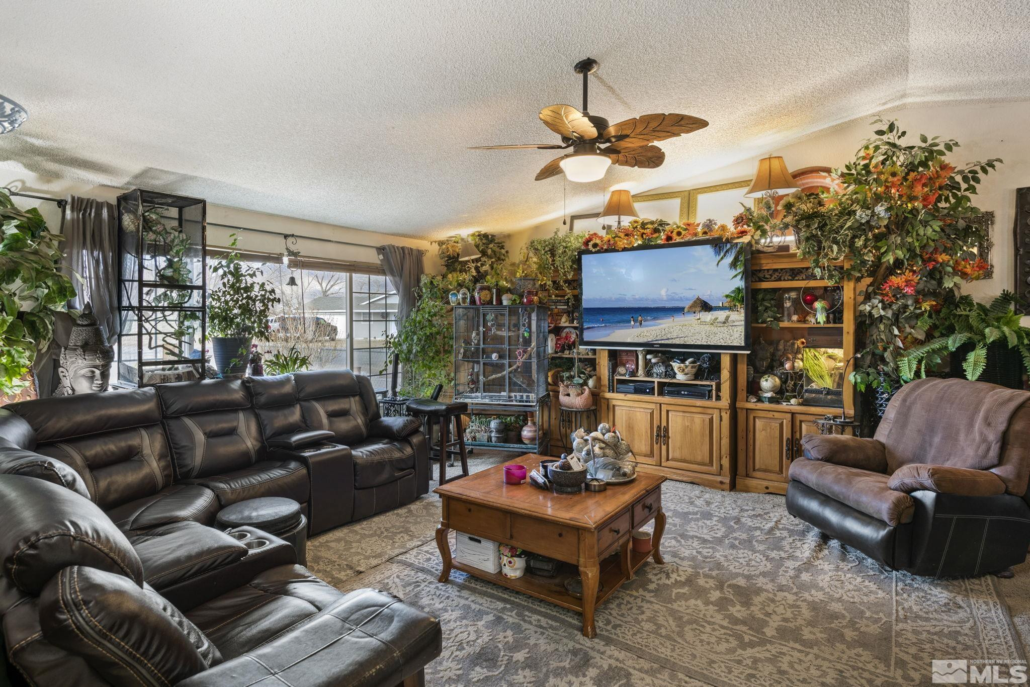 207 Ring Road Dayton, NV 89403 - Photo 12 of 40 a living room with furniture fireplace and a large window