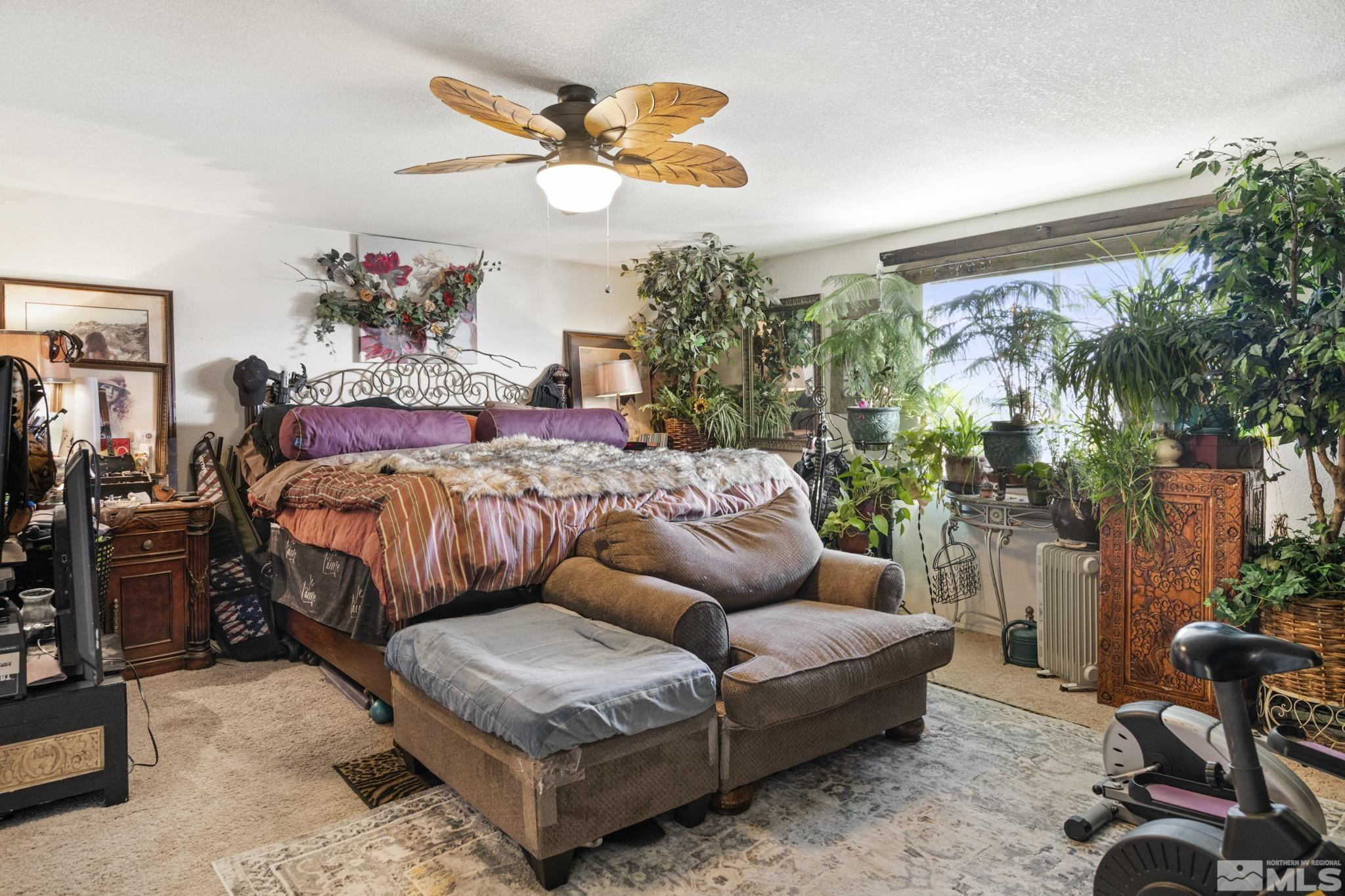 207 Ring Road Dayton, NV 89403 - Photo 19 of 40 a bedroom with a bed and a chandelier