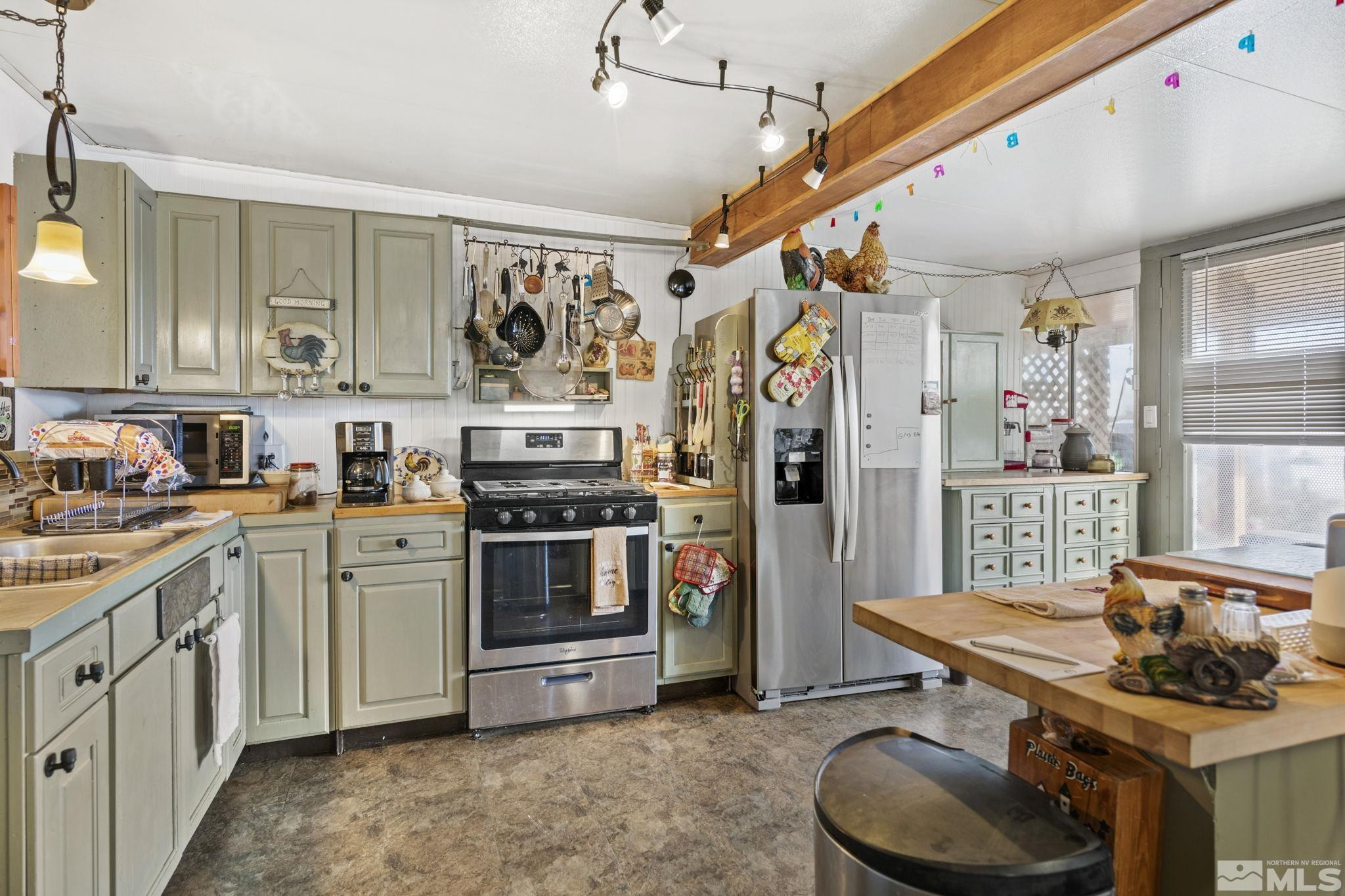 207 Ring Road Dayton, NV 89403 - Photo 2 of 40 a kitchen with stainless steel appliances granite countertop a sink stove and refrigerator