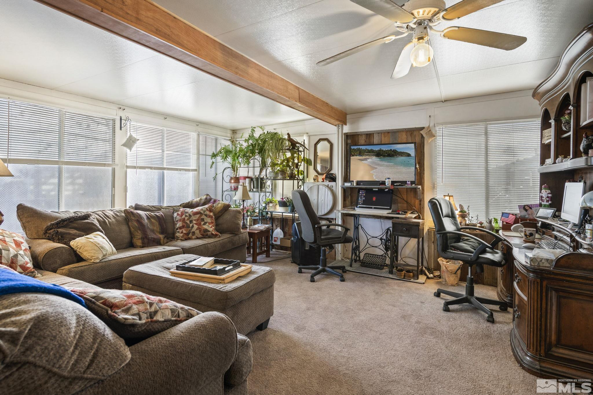 207 Ring Road Dayton, NV 89403 - Photo 7 of 40 a living room with furniture a chandelier and a flat screen tv