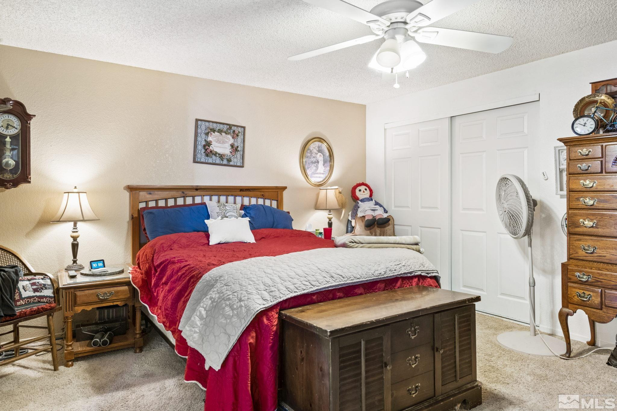 207 Ring Road Dayton, NV 89403 - Photo 8 of 40 a bedroom with a bed and a chandelier