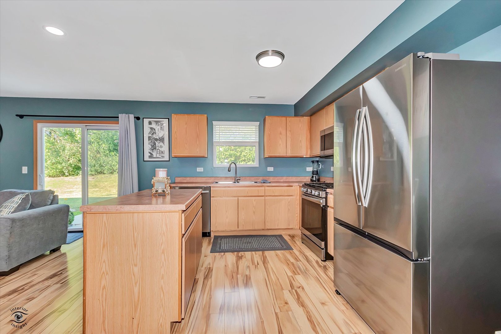25261 Faraday Road, Unit 2 Manhattan, IL 60442 - Photo 8 of 26 a kitchen with a refrigerator a sink dishwasher a stove top oven a refrigerator with island and windows