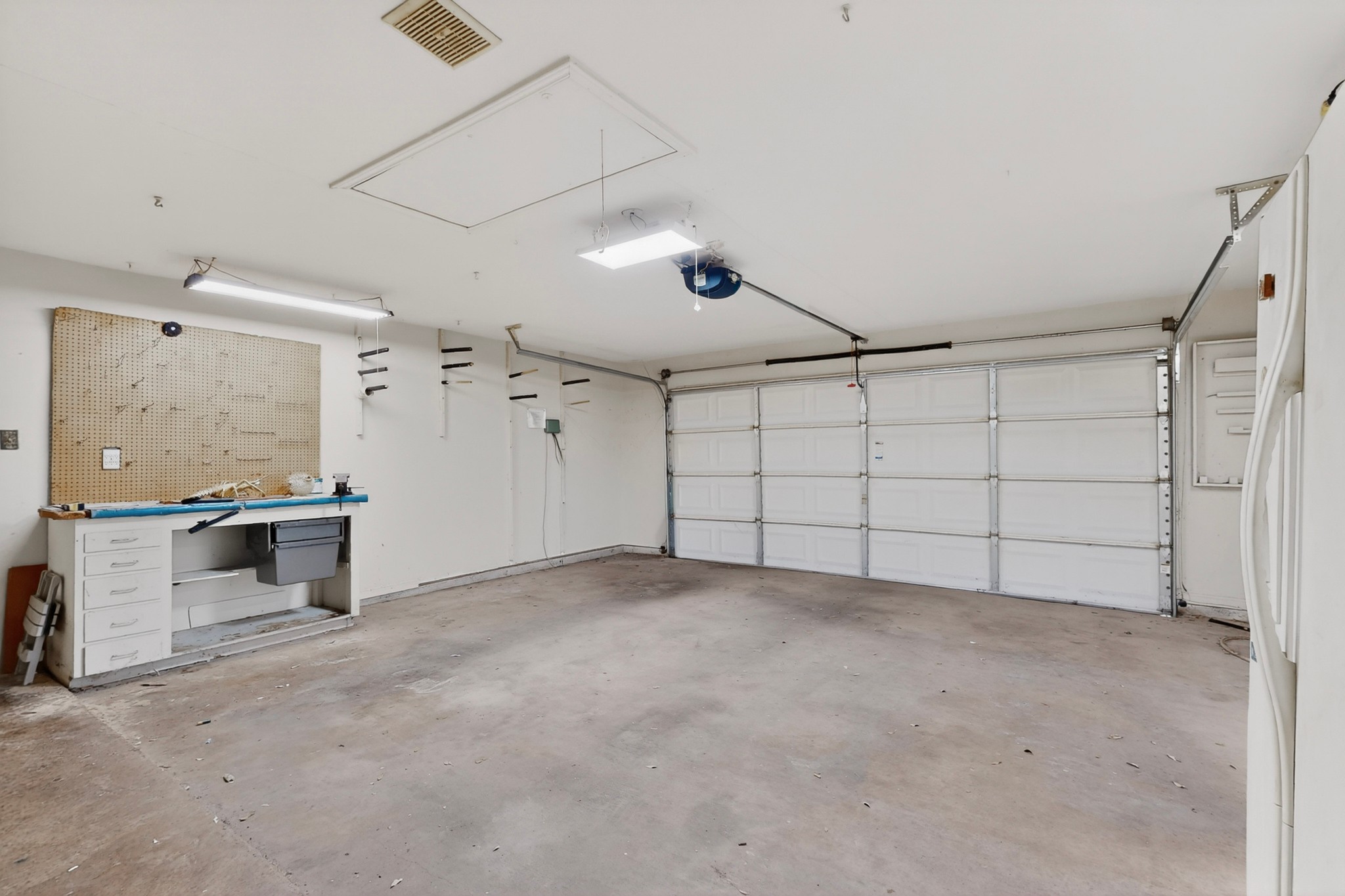 1003 Pier Branch Road Dripping Springs, TX 78620 - Photo 32 of 40 A spacious, well-lit garage offers ample workspace and convenient storage solutions.