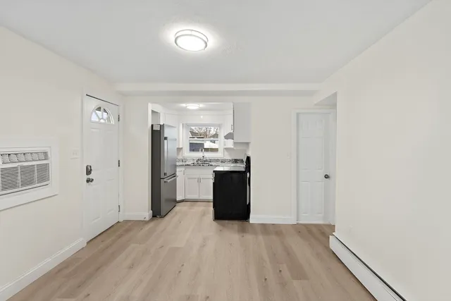 a kitchen with a refrigerator and a stove top oven