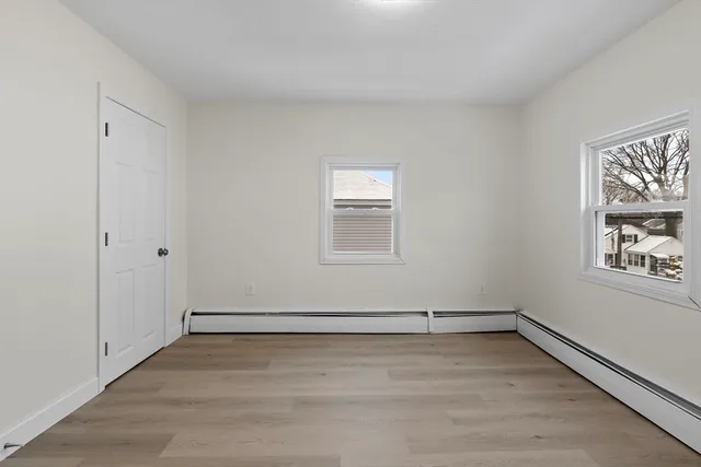 a bedroom with a bed window and table
