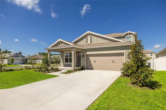 a front view of a house with a garden and plants