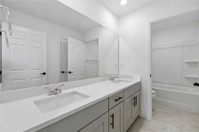 a view of a pool with a table and chairs