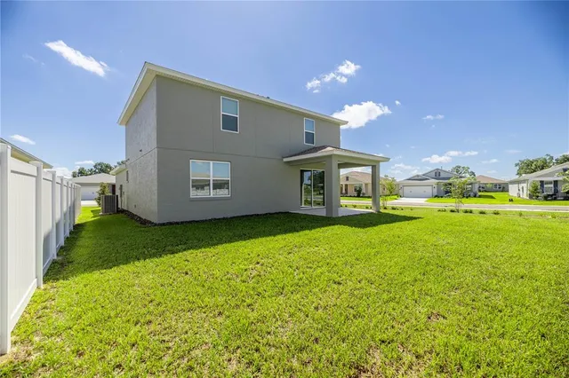 a view of a house with backyard and garden