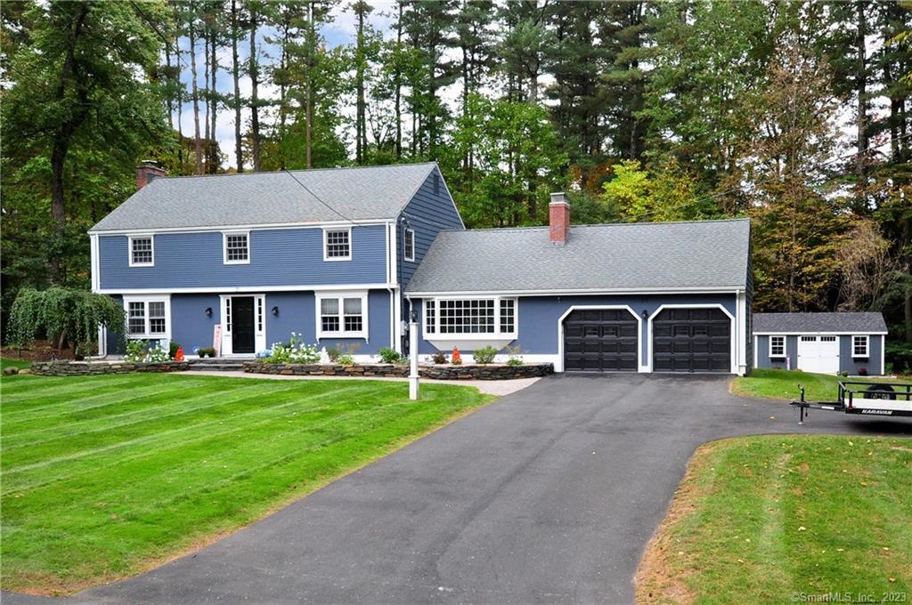 31 Sunset Hill Road Simsbury, CT 06070 - Photo 1 of 1 a front view of a house with a garden and trees