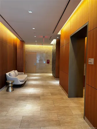 a living room with furniture a rug and a projector