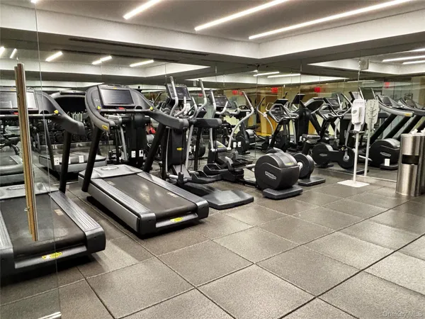 a room with lots of wooden furniture a table and chairs