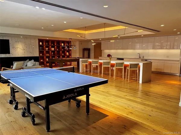 a large kitchen with a table and chairs