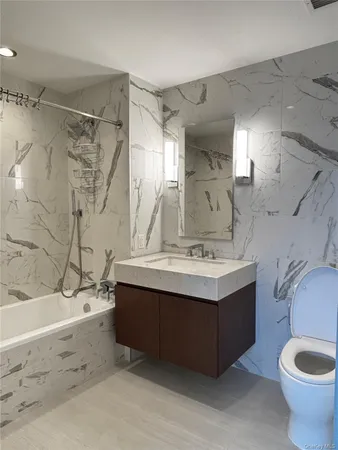 a bathroom with a sink mirror vanity and toilet