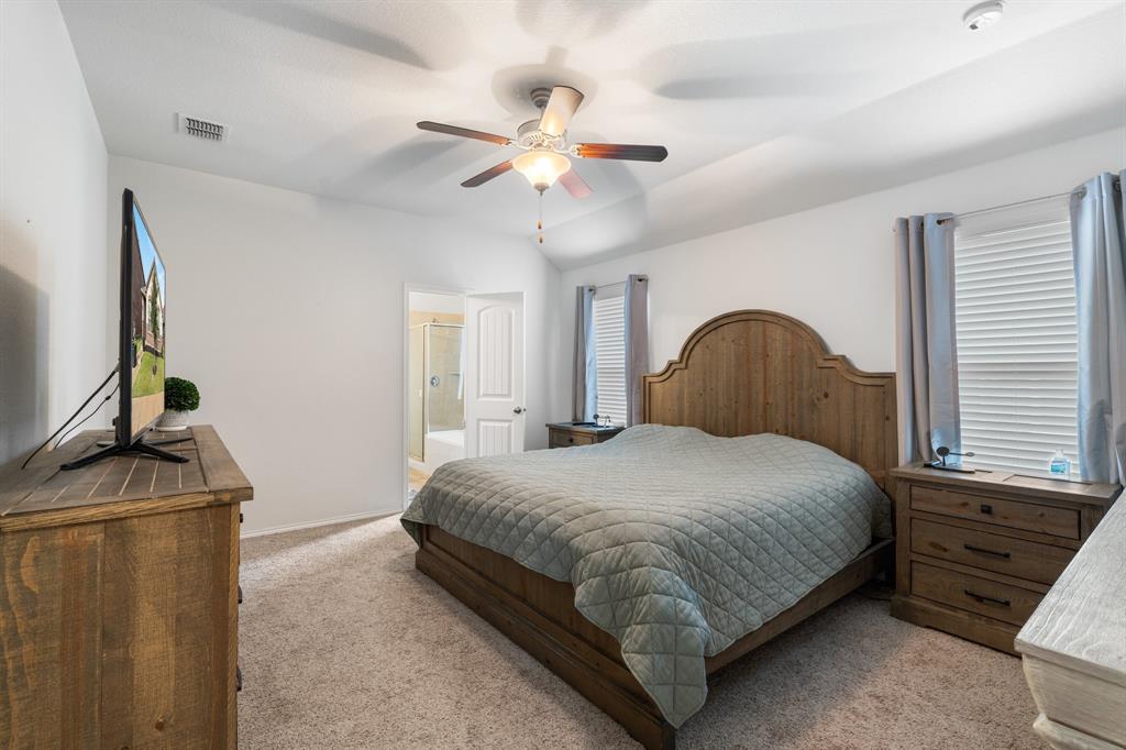 1490 Alamandine Avenue Cross Roads, TX 76227 - Photo 13 of 23 a bedroom with a bed and a chandelier