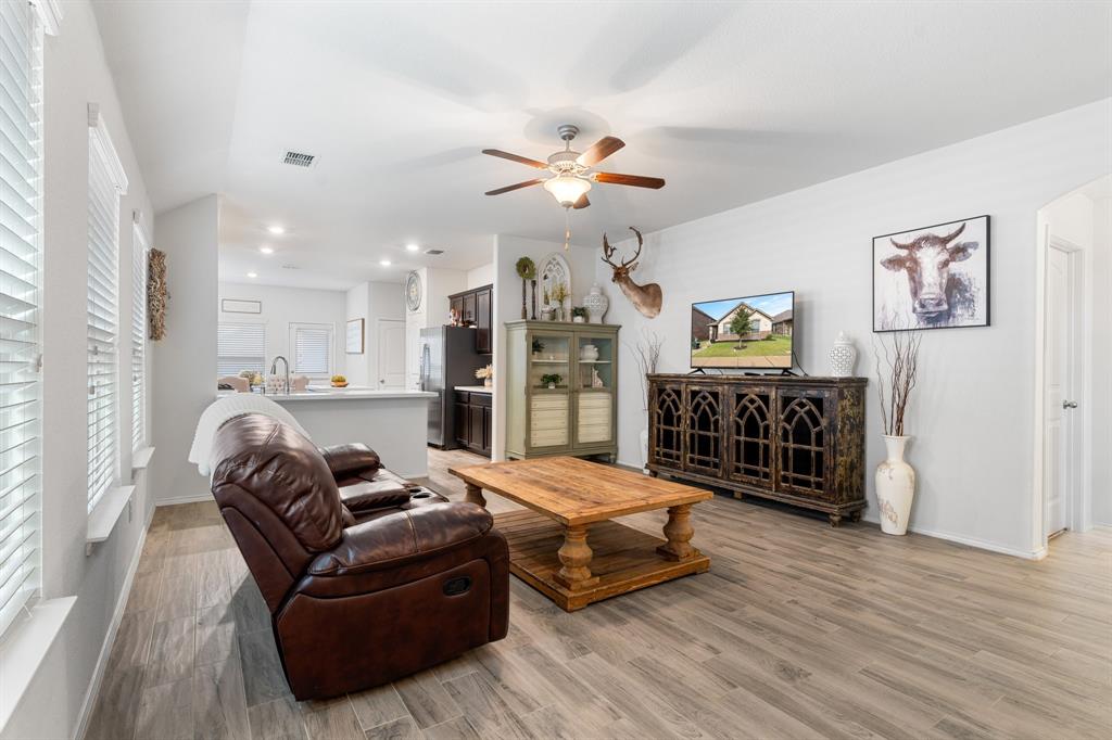 1490 Alamandine Avenue Cross Roads, TX 76227 - Photo 4 of 23 a living room with furniture and a fireplace