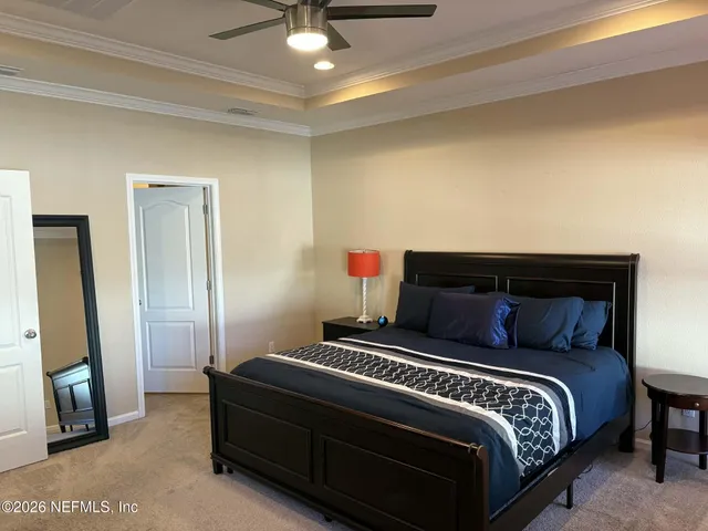 a bedroom with a bed and a chandelier