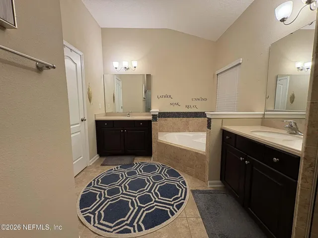 a spacious bathroom with a sink and a mirror