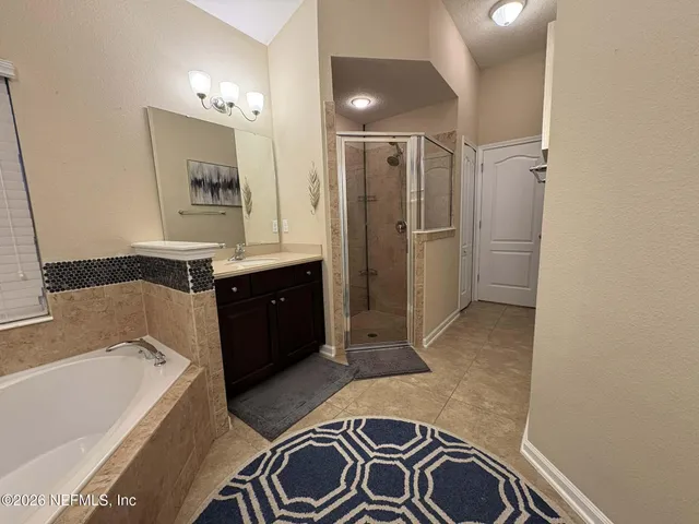 a spacious bathroom with a bathtub and a sink