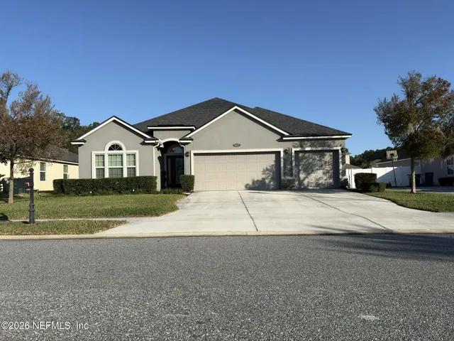 a front view of a house with a yard and garage