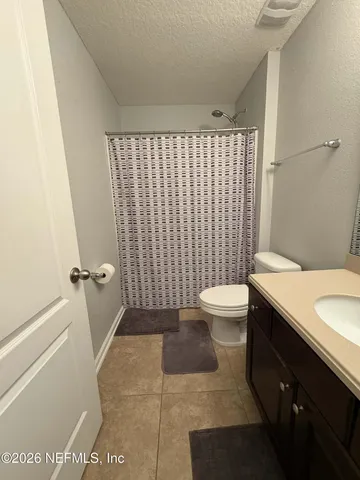 a living room with furniture a lamp and a flat screen tv