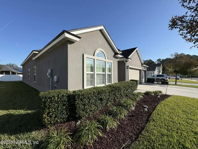 a front view of a house with a garden