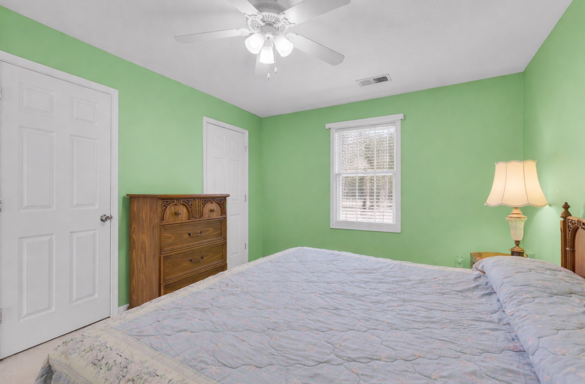 1095 Taylor Lane Newbern, TN 38059 - Photo 15 of 18 a bedroom with a bed and a chandelier