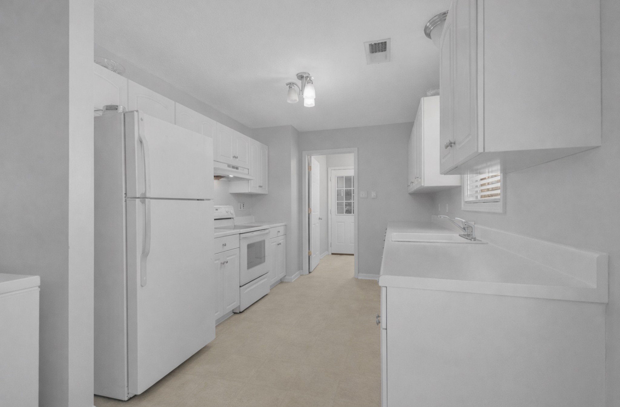 1095 Taylor Lane Newbern, TN 38059 - Photo 8 of 18 a kitchen with white cabinets and white appliances