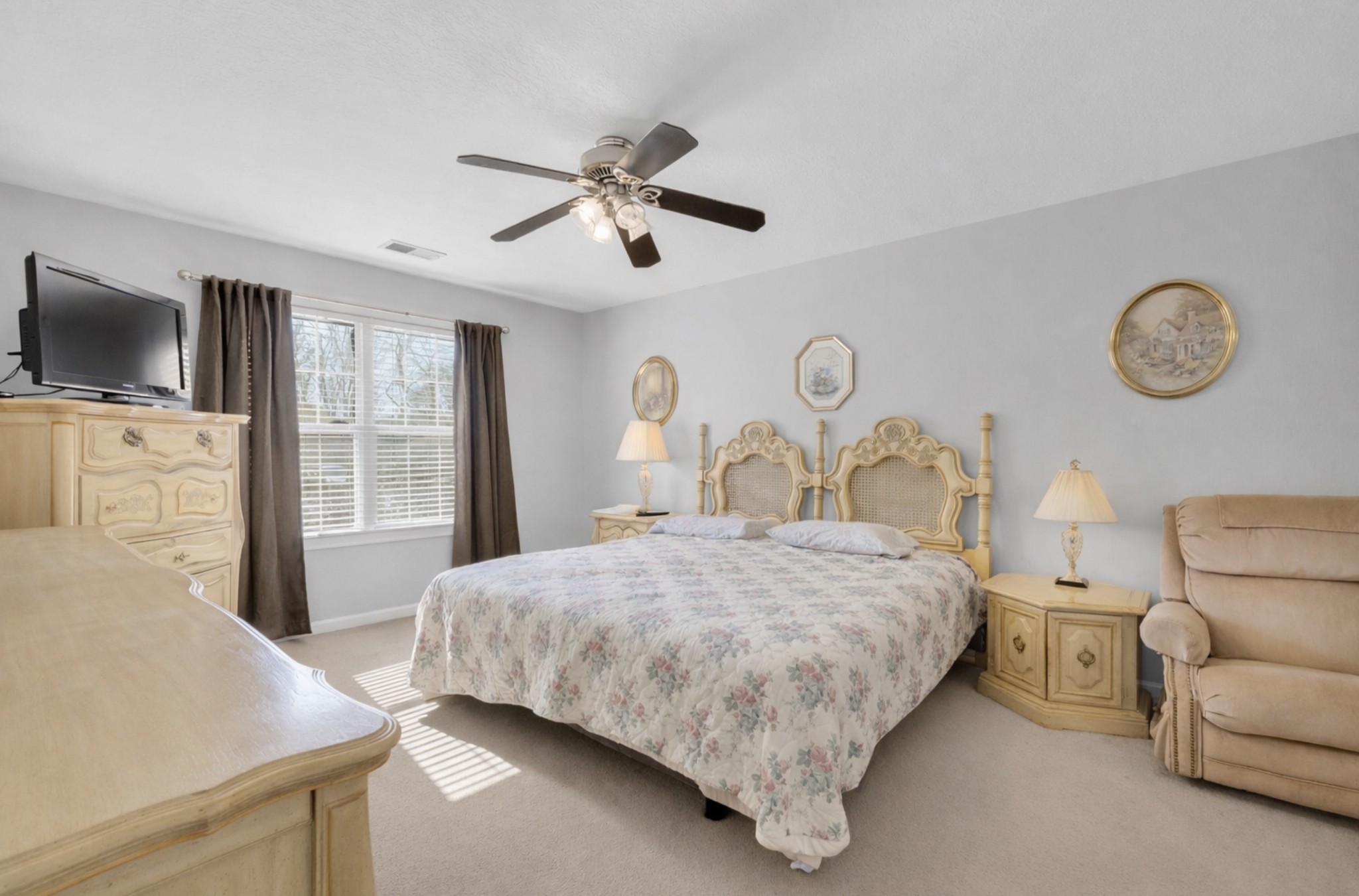 1095 Taylor Lane Newbern, TN 38059 - Photo 9 of 18 a bedroom with a bed a flat screen tv and dresser