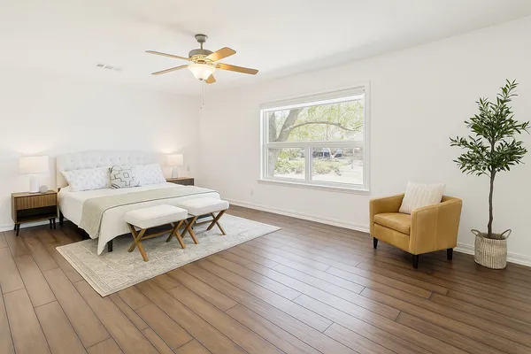 a bedroom with a bed and a couch