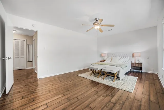 a bedroom with a bed and wooden floor