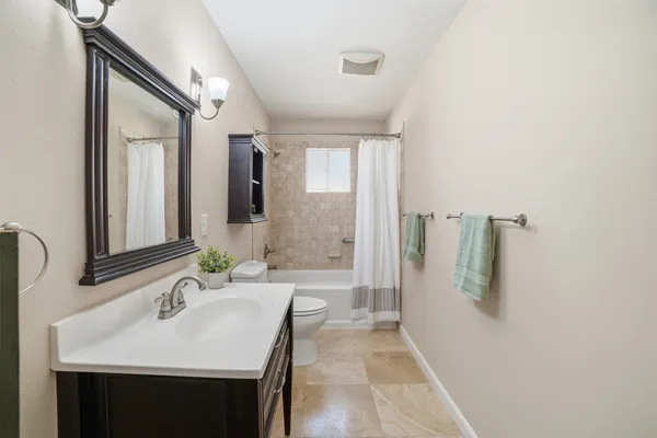 a bathroom with a sink a mirror and a bathtub