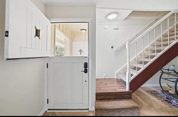 a view of entryway and hall with wooden floor