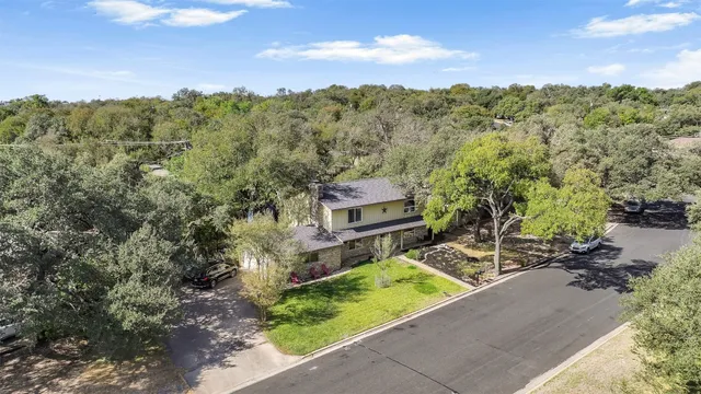 an aerial view of a house with a yard