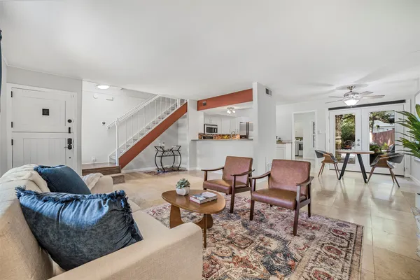 a living room with furniture and wooden floor