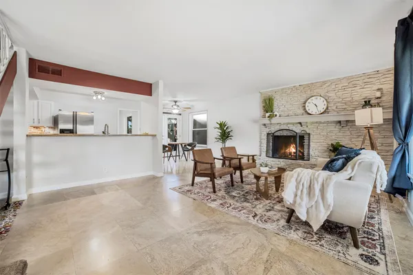 a living room with furniture a clock and a clock
