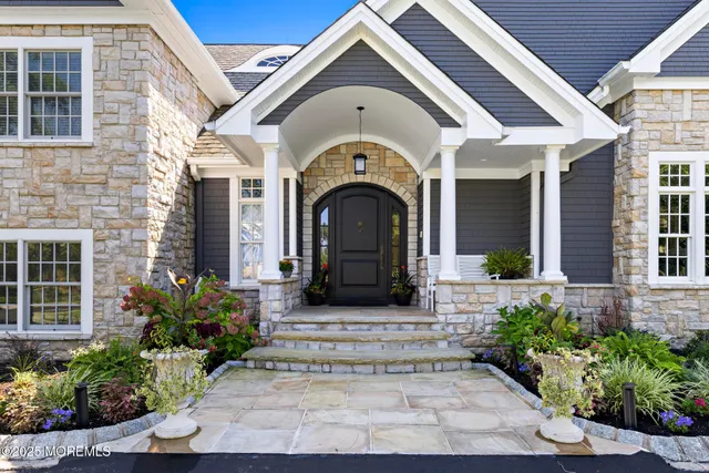 a view of a dining room with furniture large windows and wooden floor