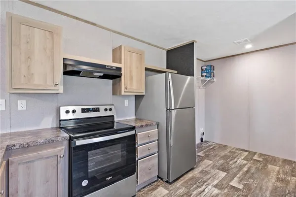 a kitchen with a stove microwave and refrigerator