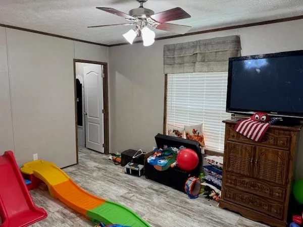 a bedroom with furniture and a flat screen tv
