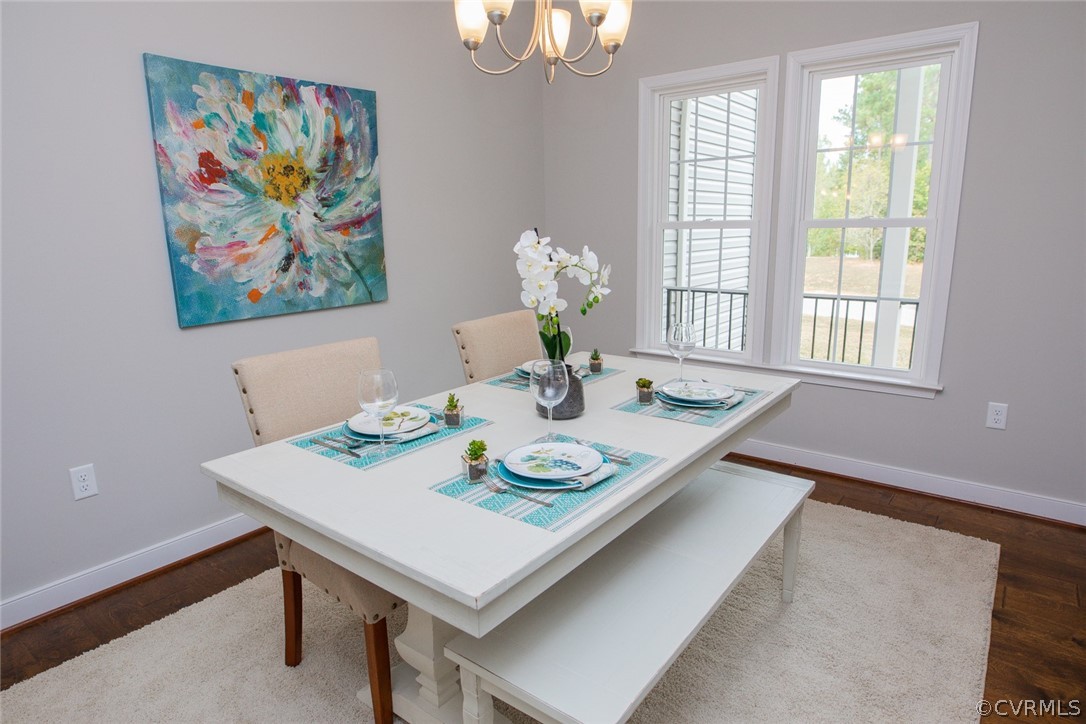 0 Corte Castle Road Chesterfield, VA 23838 - Photo 12 of 37 a view of a dining room with furniture a chandelier and wooden floor
