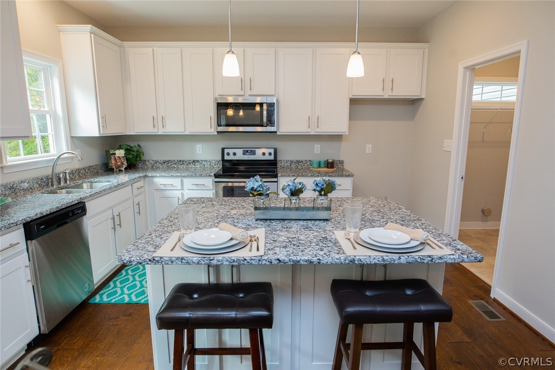 0 Corte Castle Road Chesterfield, VA 23838 - Photo 9 of 37 a kitchen with stainless steel appliances a white table and chairs in it