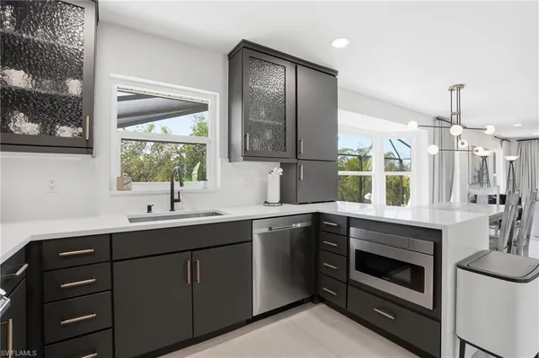 a kitchen with a sink stove and microwave