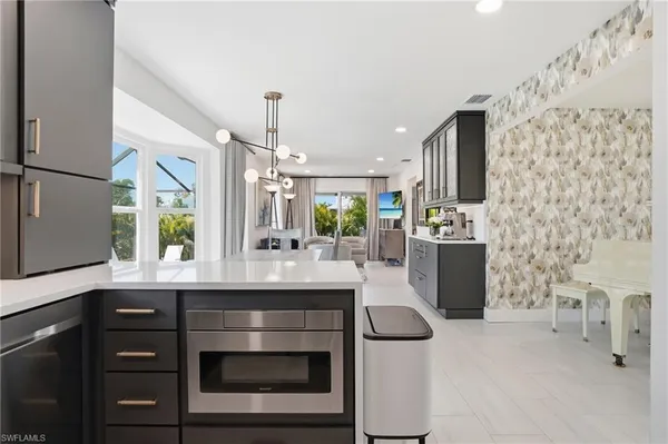 a kitchen with stainless steel appliances kitchen island granite countertop a sink and cabinets