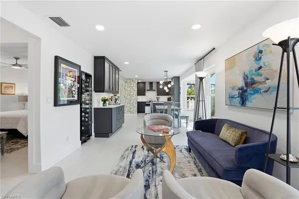 a living room with furniture and a kitchen view