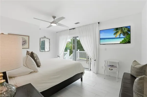 a bedroom with a bed a couch and a window