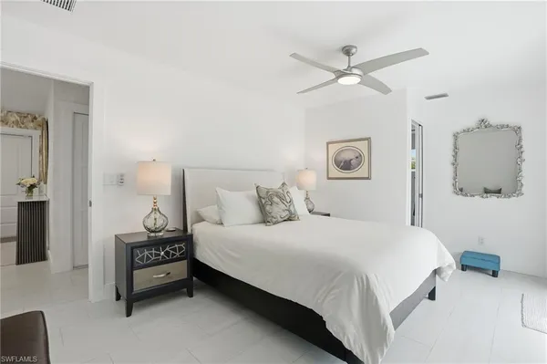 a bedroom with a bed and a ceiling fan