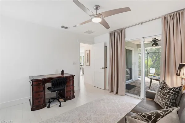 a livingroom with workspace and a couch