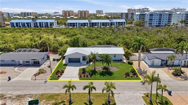 an aerial view of a house with a garden and lake view