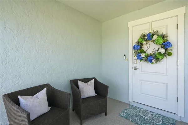 a living room with furniture and flowers