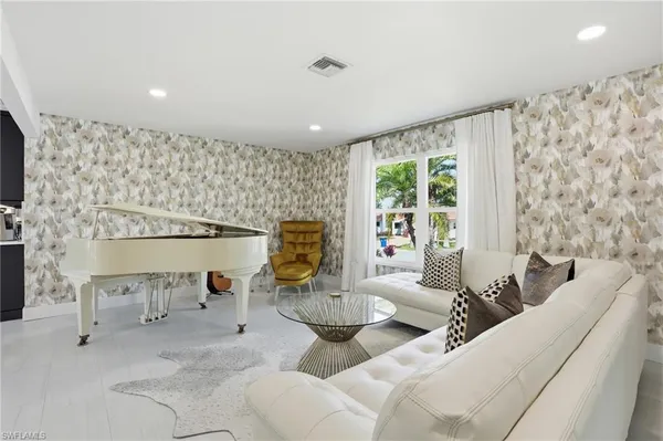 a living room with furniture and a large window