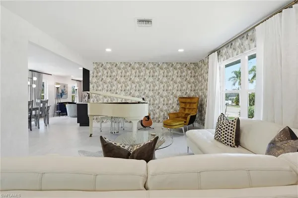 a living room with furniture and a large window